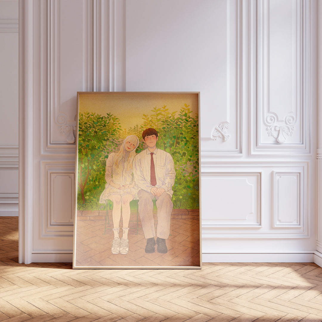Framed artwork of two people sitting together on a wall with decorative molding.